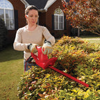 17 in. 2.7 Amp Electric Hedge Trimmer cutting front yard hedges